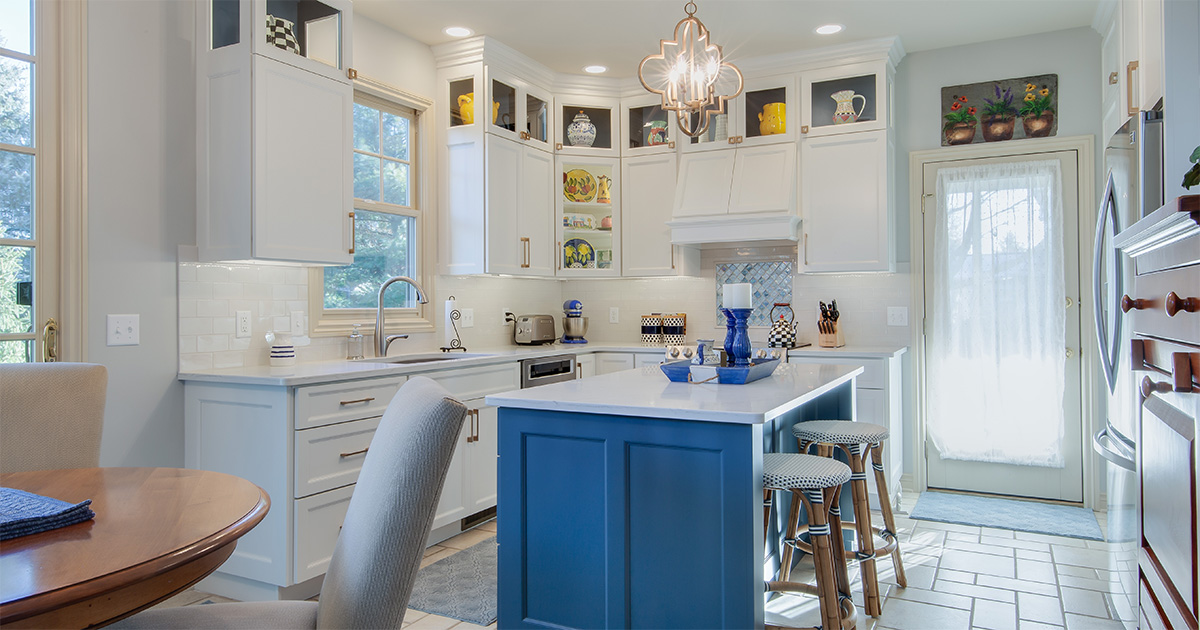 PMV Is Working With An Interior Paint Color Consultant Worth It 2 Freshly painted kitchen with white cabinets and a blue island.