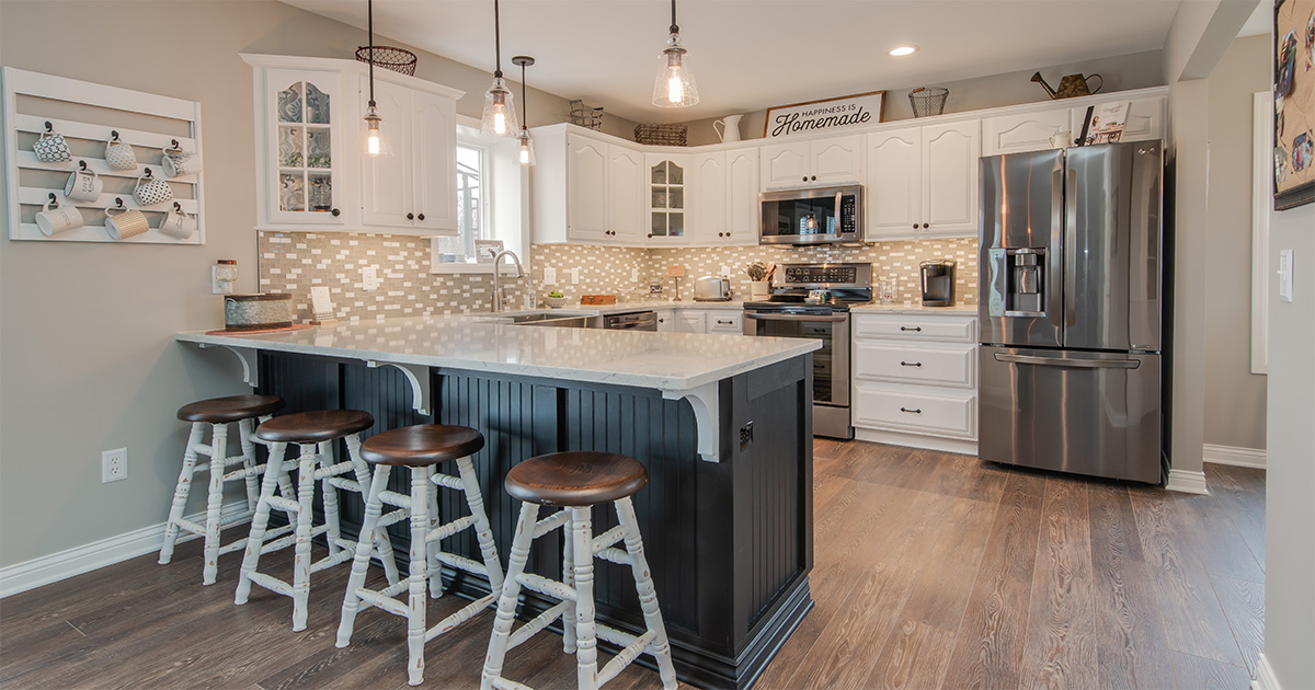 PMV Is Working With An Interior Paint Color Consultant Worth It Kitchen with freshly painted cabinets. White cabinets with a dark gray island.