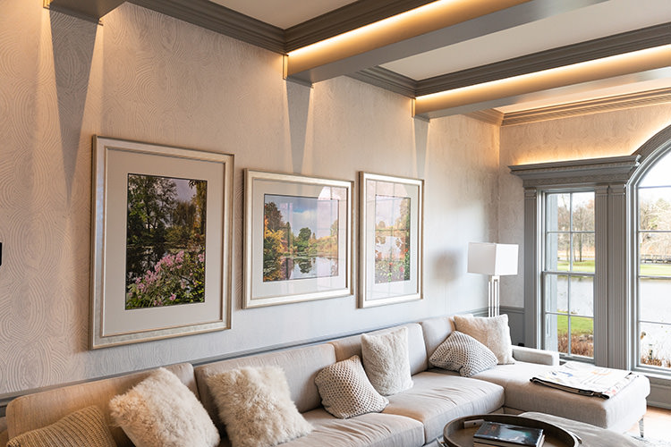 PMV - Project Highlight - Contemporary Lakehouse Living Areas Entertainment 3 Sitting room with 3 large photos in frames above the couch.