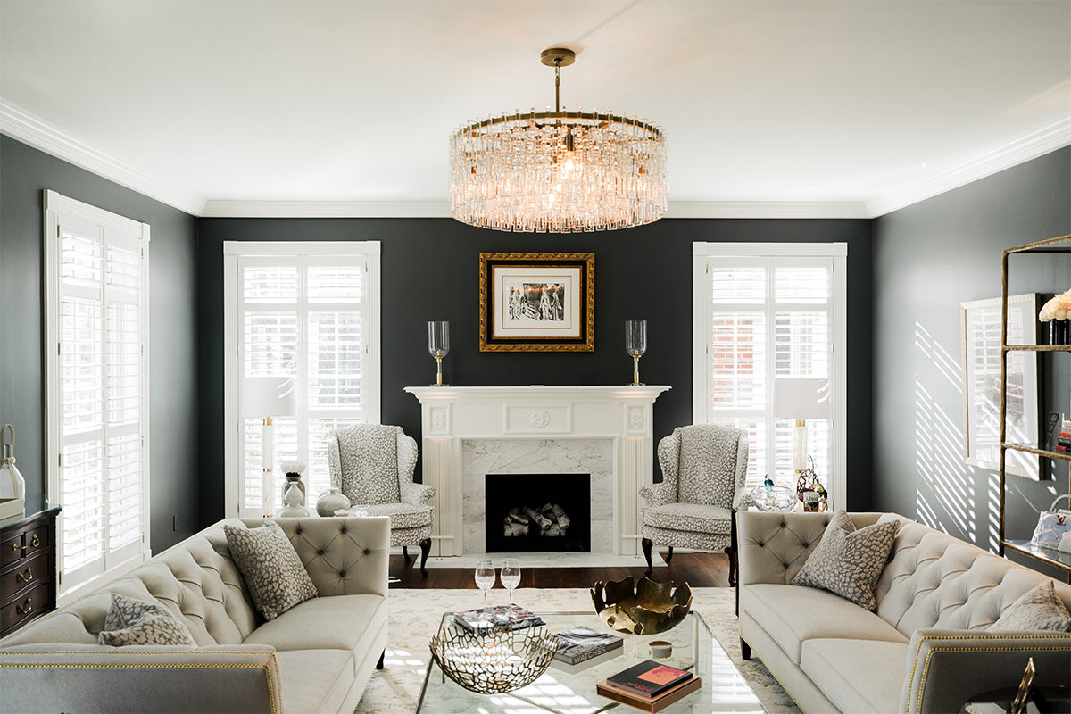 PMV - Project Highlight - Contemporary Lakehouse Living Areas Main 1 Dark and moody sitting room with two couches and a white fireplace.
