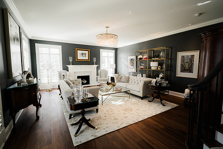 PMV - Project Highlight - Contemporary Lakehouse Living Areas Main 2 Dark and moody sitting room with two couches and a white fireplace.