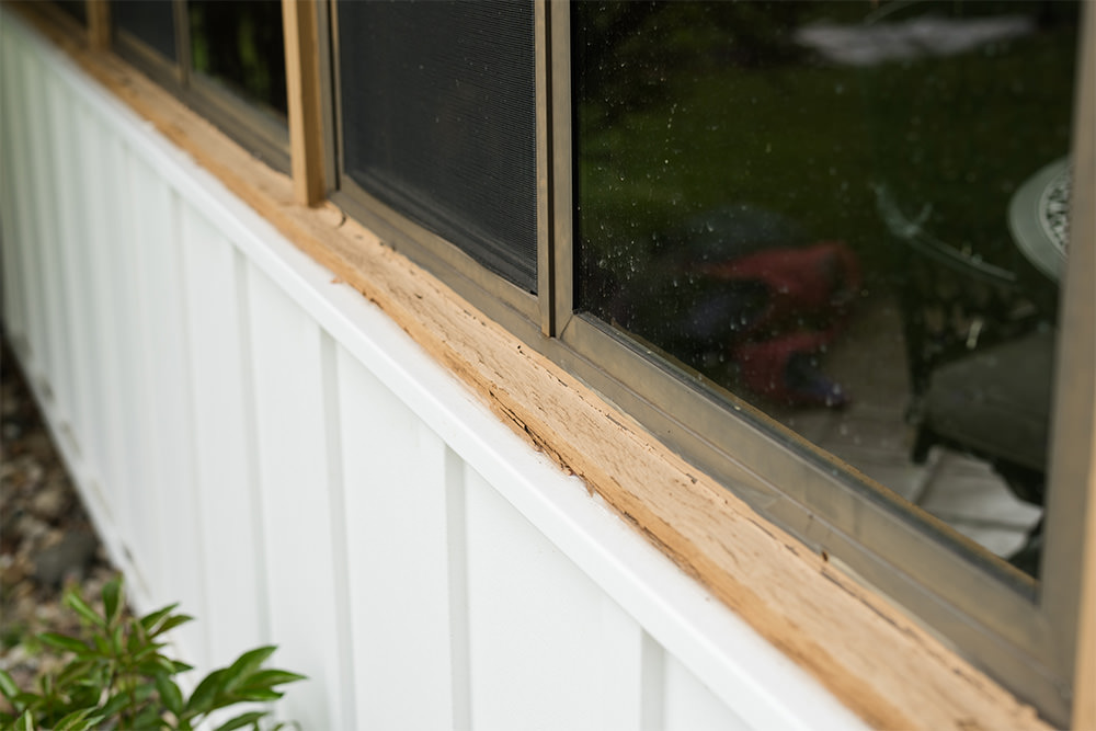 Flaking paint on siding of house.